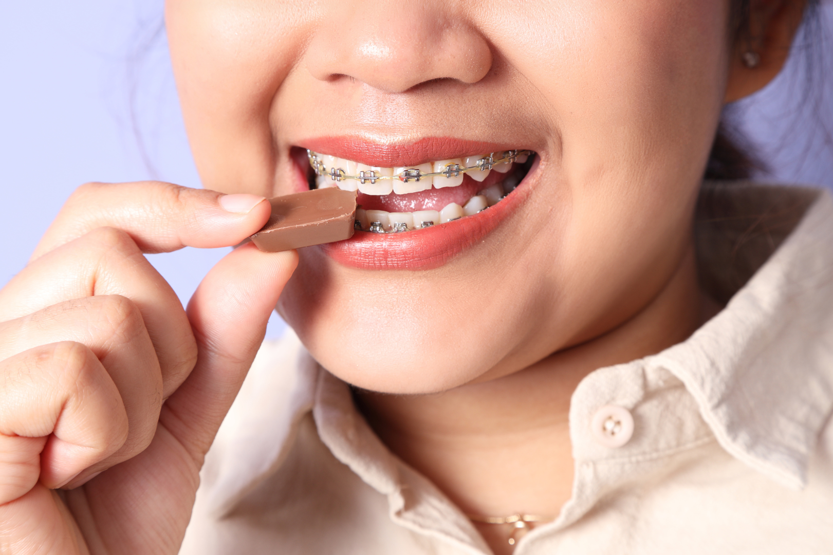 Girl with braces eating chocolate 